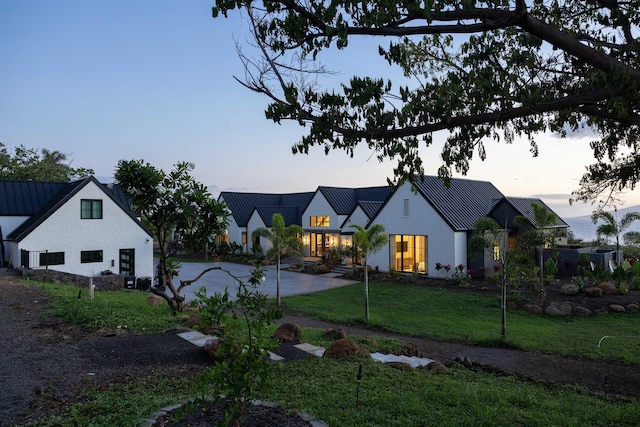 modern farmhouse style home featuring a yard