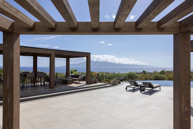 view of patio / terrace featuring an outdoor hangout area, a water view, and a pergola