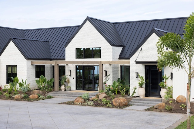 modern farmhouse style home featuring french doors