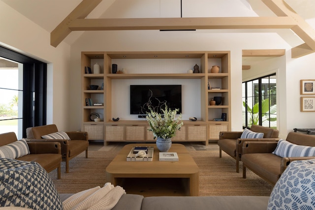 living room with vaulted ceiling with beams