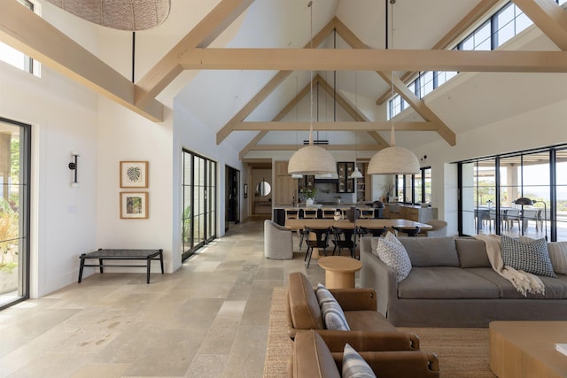 living room with beamed ceiling and high vaulted ceiling