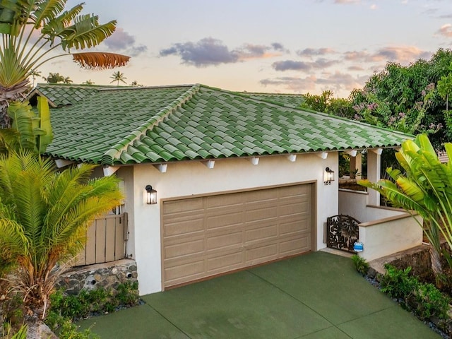 view of garage at dusk