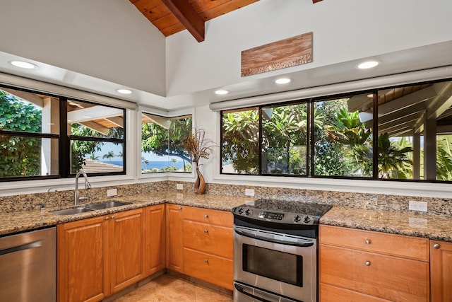 kitchen with sink, appliances with stainless steel finishes, beam ceiling, light stone counters, and wood ceiling