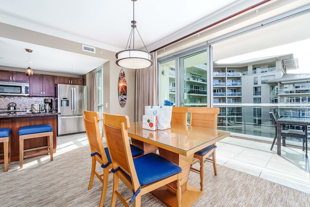 tiled dining space with ornamental molding