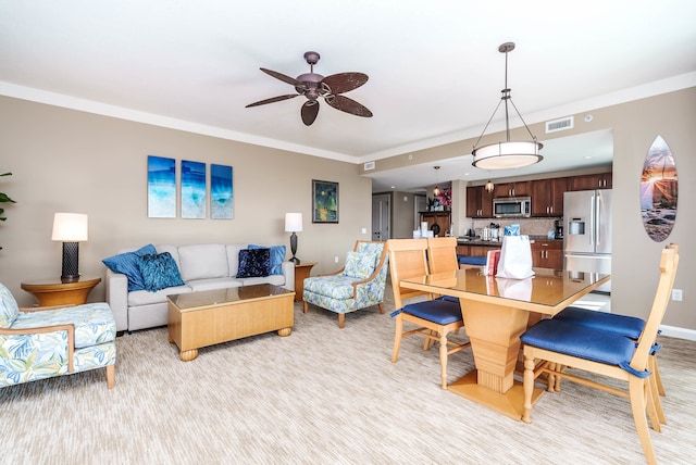 living room with ornamental molding and ceiling fan