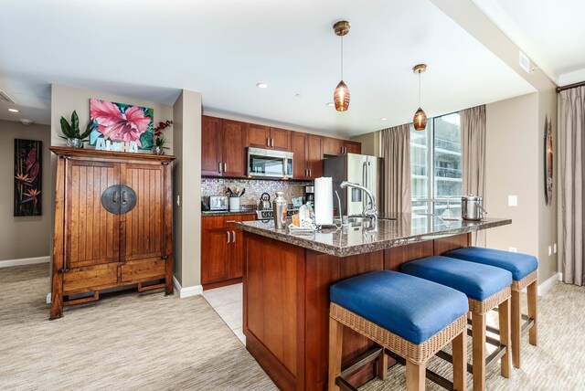 kitchen featuring sink, appliances with stainless steel finishes, decorative backsplash, and light colored carpet