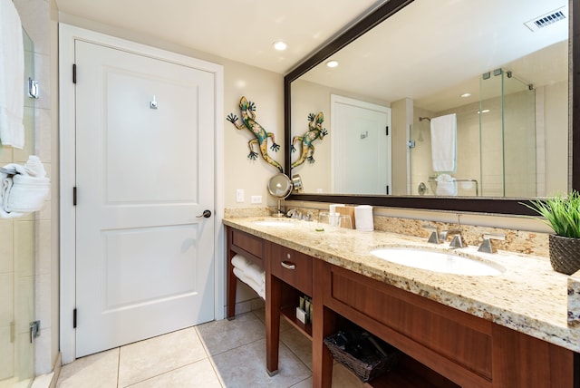 bathroom featuring tile patterned flooring, vanity, and an enclosed shower