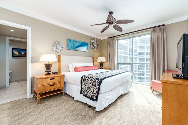 tiled bedroom with ornamental molding and ceiling fan