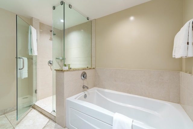 bathroom with independent shower and bath and tile patterned floors