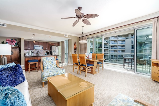 living room with light carpet and ceiling fan