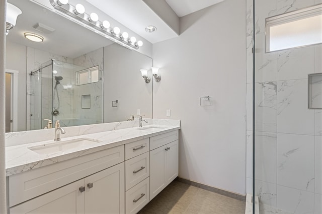 bathroom with a shower with door and vanity