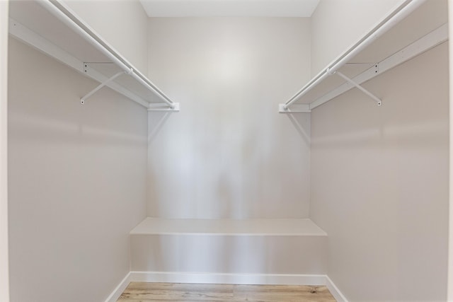 spacious closet featuring hardwood / wood-style flooring