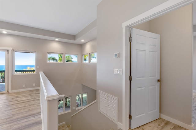 corridor with light hardwood / wood-style floors