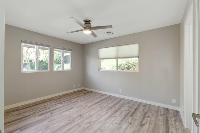 spare room featuring light wood-type flooring and ceiling fan