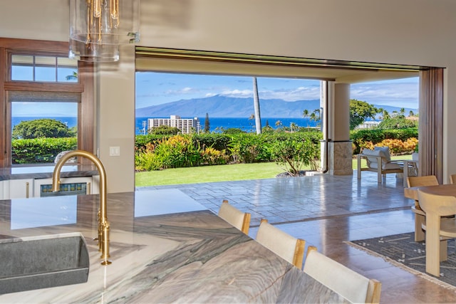 dining space featuring a mountain view and sink