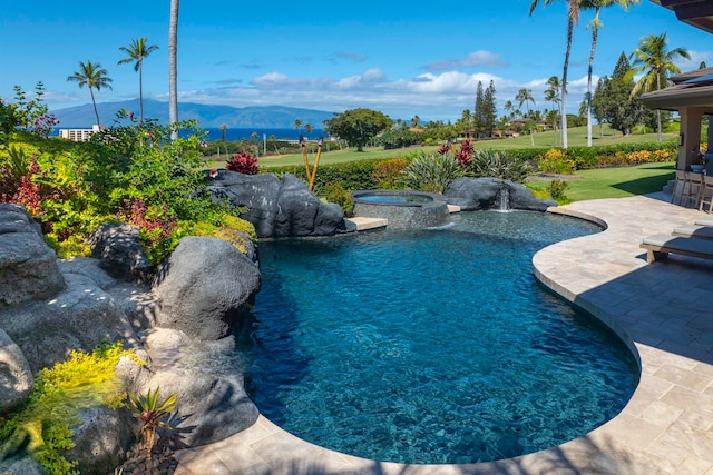 view of pool featuring a lawn, a mountain view, an in ground hot tub, and a patio