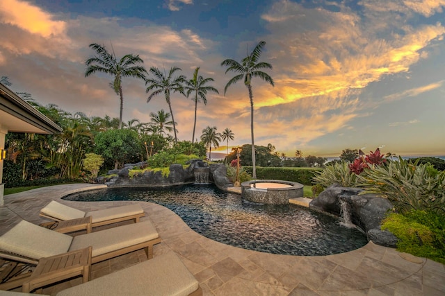 exterior space featuring pool water feature and a swimming pool with hot tub