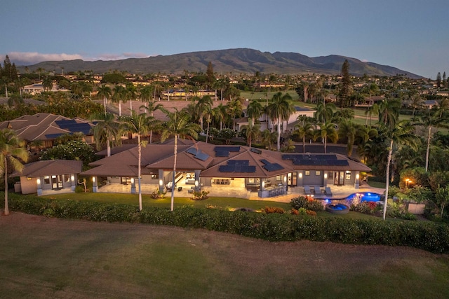 aerial view at dusk featuring a mountain view