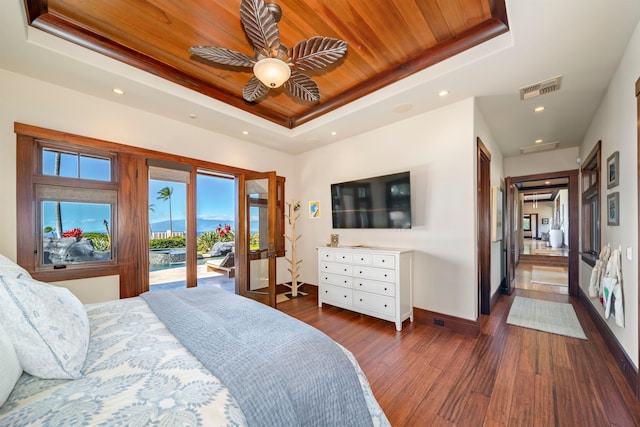 bedroom featuring ceiling fan, a raised ceiling, dark hardwood / wood-style flooring, access to outside, and wood ceiling