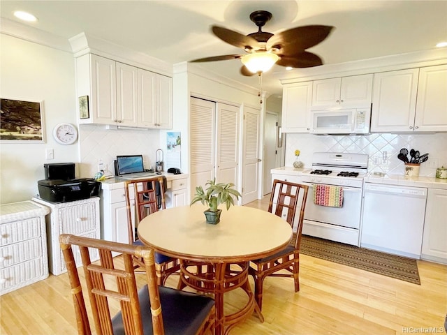 7146 Kamehameha V Hwy Unit 207C, Kaunakakai, HI 96748 - kitchen with white appliances, a ceiling fan, tile countertops, white cabinetry, and recessed lighting