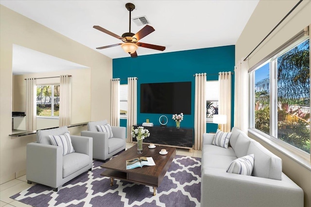 living room featuring tile patterned flooring, a ceiling fan, and visible vents