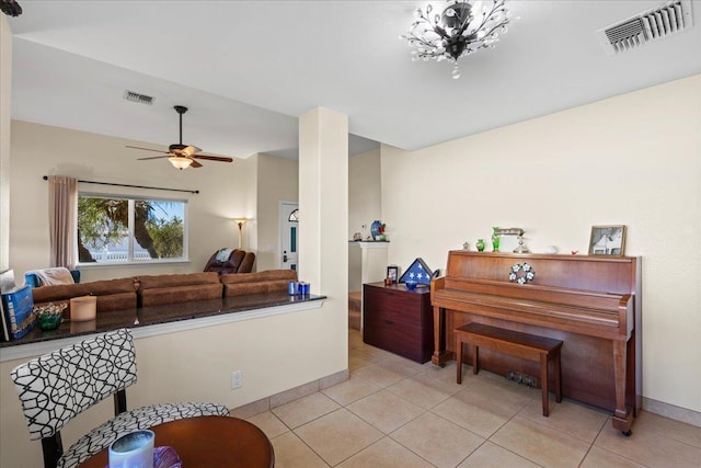 kitchen featuring visible vents, baseboards, light tile patterned flooring, and a ceiling fan