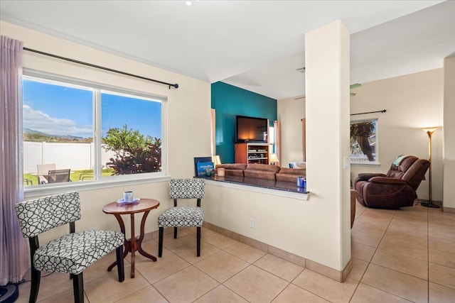 living area with light tile patterned floors and baseboards