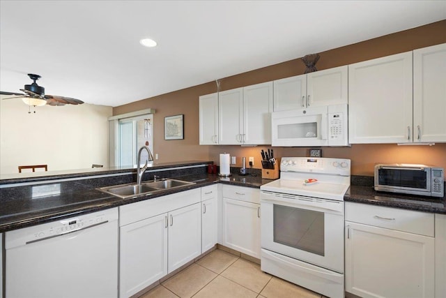 kitchen with white appliances, a toaster, light tile patterned flooring, a sink, and white cabinetry