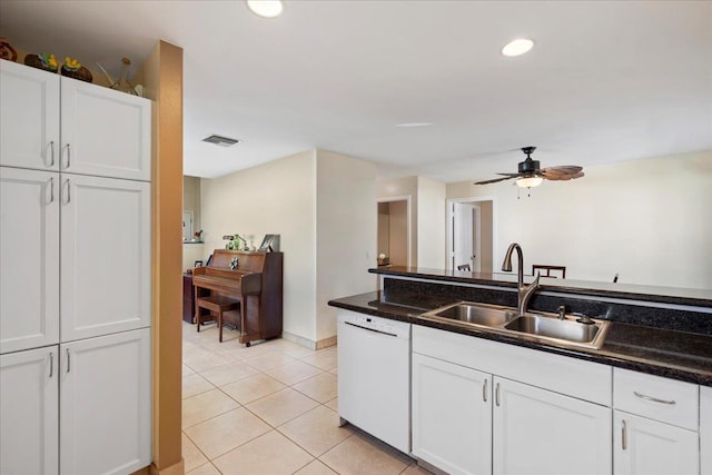 kitchen featuring visible vents, white dishwasher, light tile patterned flooring, white cabinets, and a sink