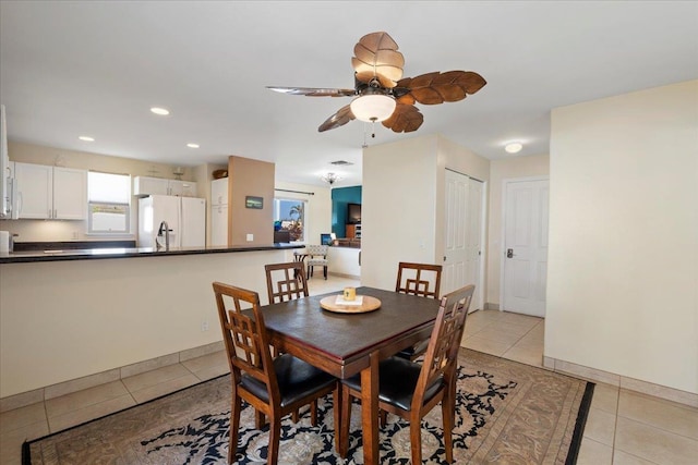 dining space with light tile patterned floors, recessed lighting, and baseboards