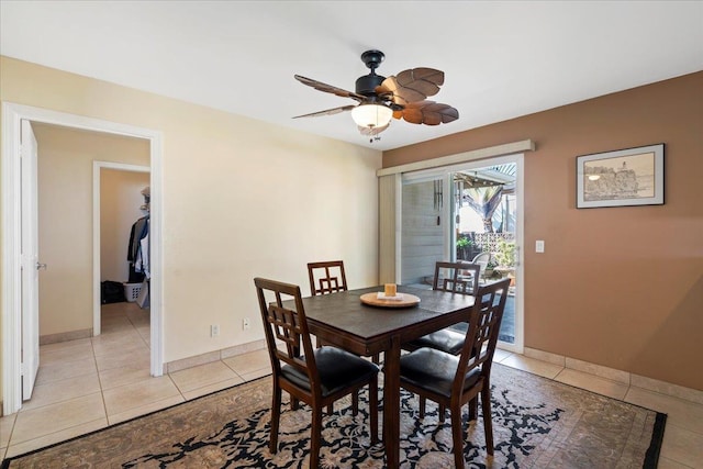 dining area featuring light tile patterned floors, baseboards, and ceiling fan