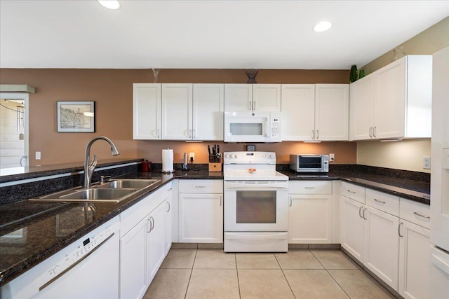 kitchen with white cabinets, white appliances, and a sink