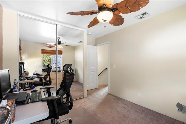 office area featuring visible vents, light carpet, and a ceiling fan