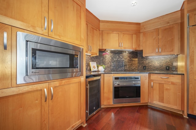 kitchen with wine cooler, dark hardwood / wood-style floors, backsplash, dark stone counters, and appliances with stainless steel finishes