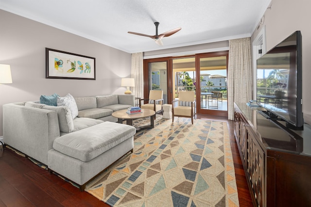 living room with ceiling fan, dark hardwood / wood-style flooring, a textured ceiling, and ornamental molding