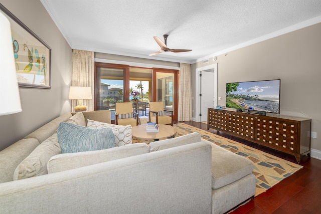 living room with ceiling fan, dark hardwood / wood-style flooring, crown molding, and a textured ceiling