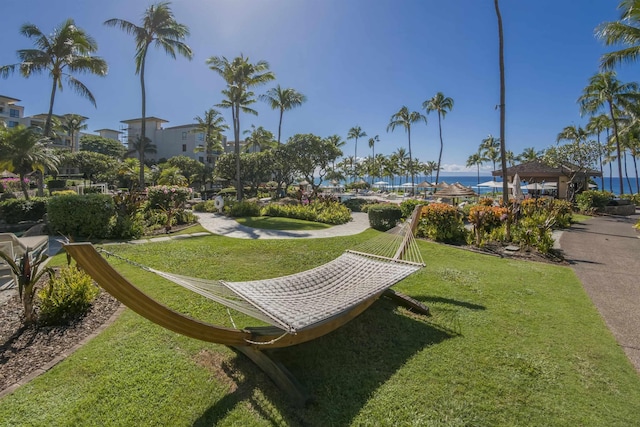 surrounding community featuring a gazebo, a yard, and a water view