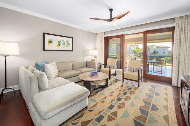 living room featuring ceiling fan, dark wood-type flooring, and ornamental molding