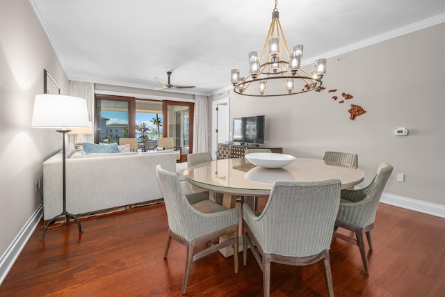 dining room featuring ceiling fan with notable chandelier, dark hardwood / wood-style floors, and crown molding