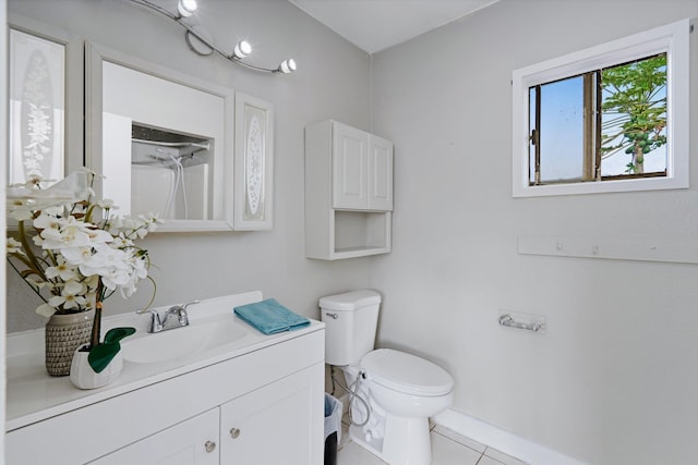 bathroom with tile patterned floors, vanity, toilet, and a shower