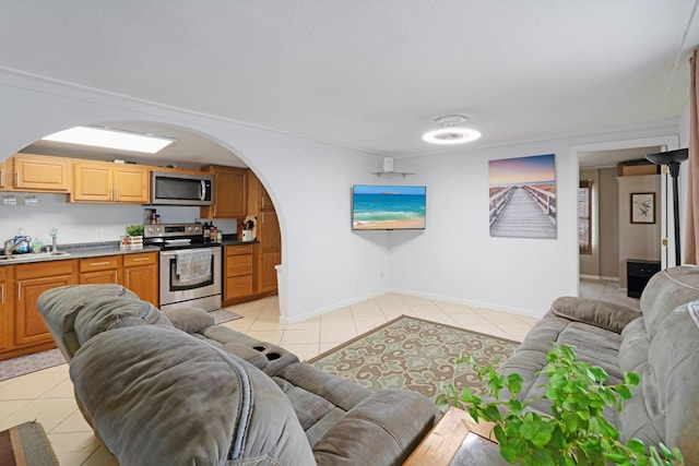 living room with light tile patterned floors and sink