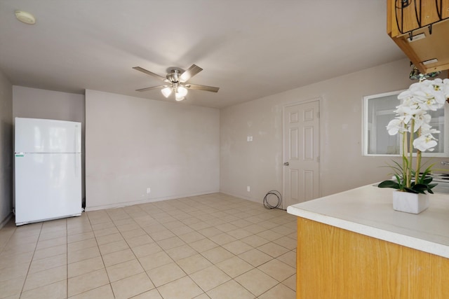 kitchen featuring ceiling fan, white fridge, and light tile patterned floors