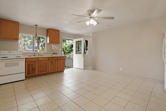 kitchen featuring light tile patterned flooring, sink, decorative light fixtures, electric range, and ceiling fan