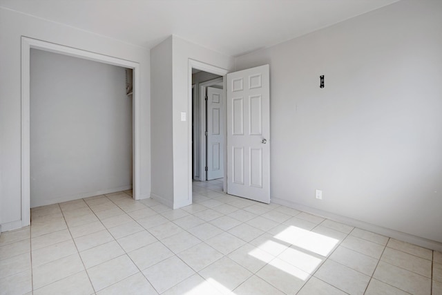 unfurnished bedroom featuring a closet and light tile patterned flooring