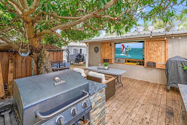 wooden terrace with a grill