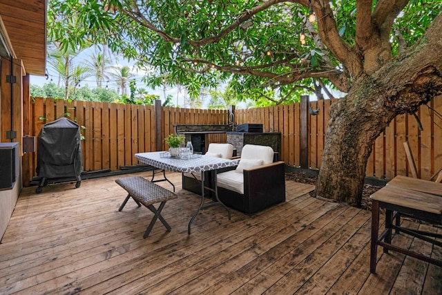 wooden deck with grilling area and exterior kitchen