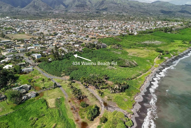 drone / aerial view featuring a water and mountain view