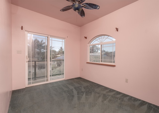 carpeted empty room featuring a wealth of natural light and ceiling fan