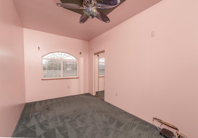 empty room with carpet flooring and ceiling fan