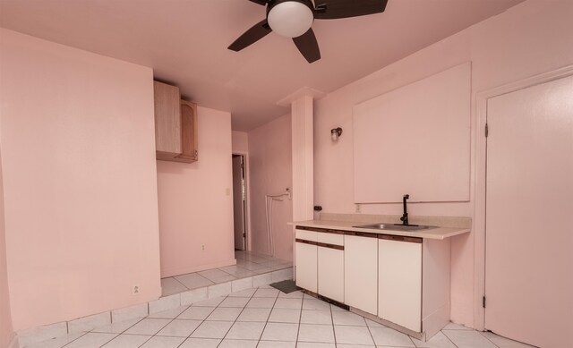 kitchen featuring light brown cabinets, light tile patterned floors, ceiling fan, and sink